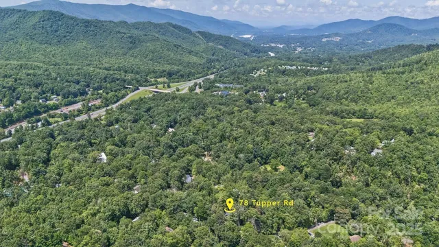 a view of a lush green hillside and a building