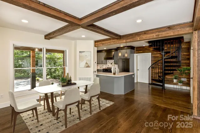 a dining room with furniture and wooden floor