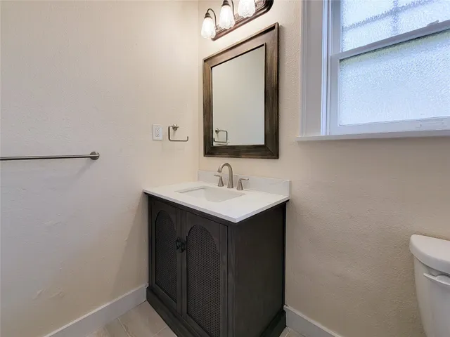 a bathroom with a sink vanity and a mirror