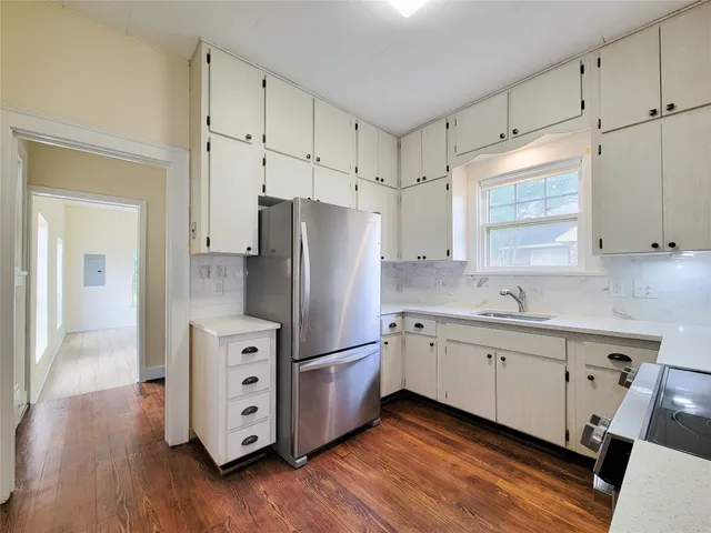 a kitchen with stainless steel appliances a refrigerator sink and cabinets