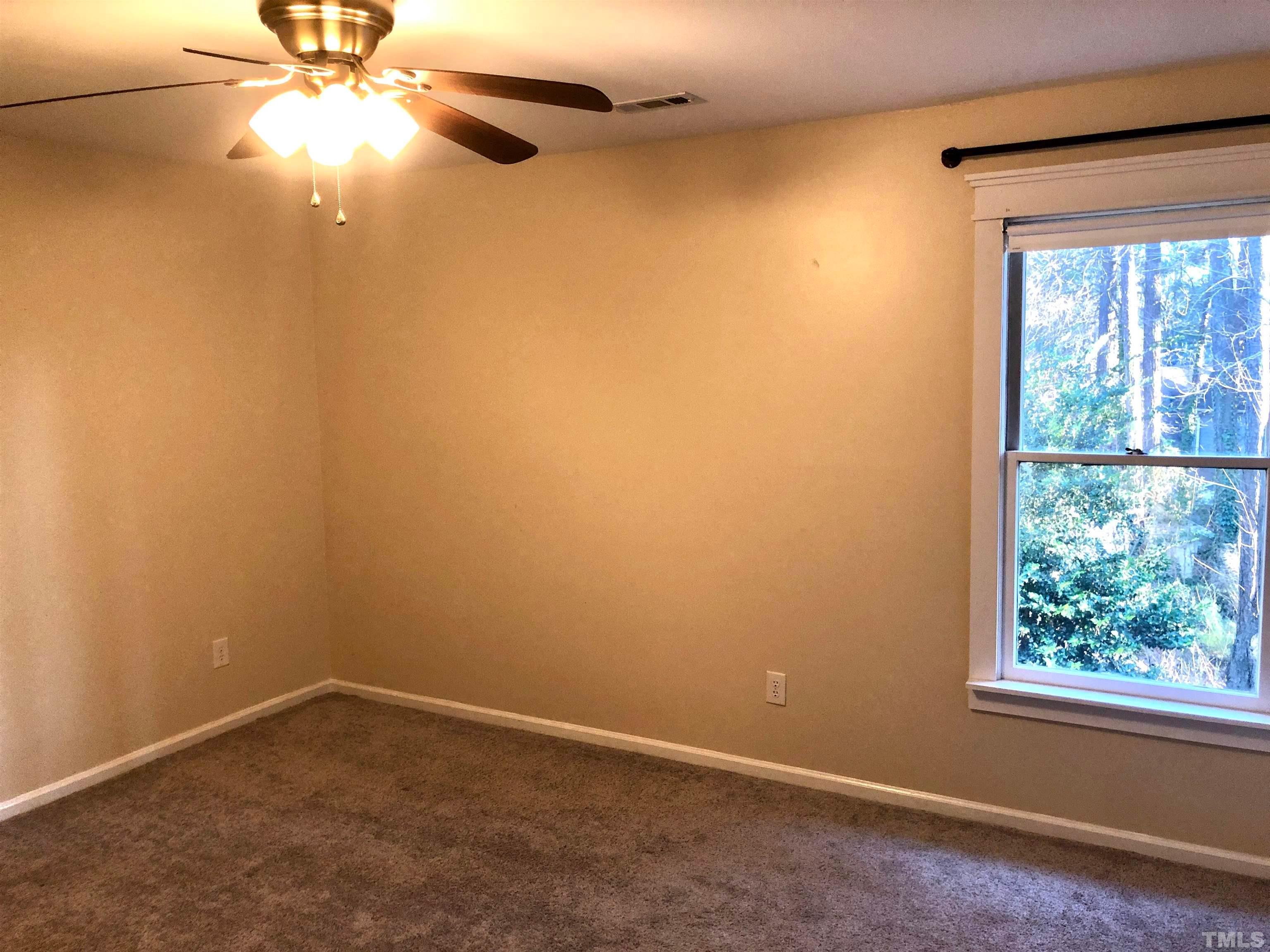 5629 Hamstead Crossing Raleigh, NC 27612 - Photo 15 of 28 an empty room with a window and a fan