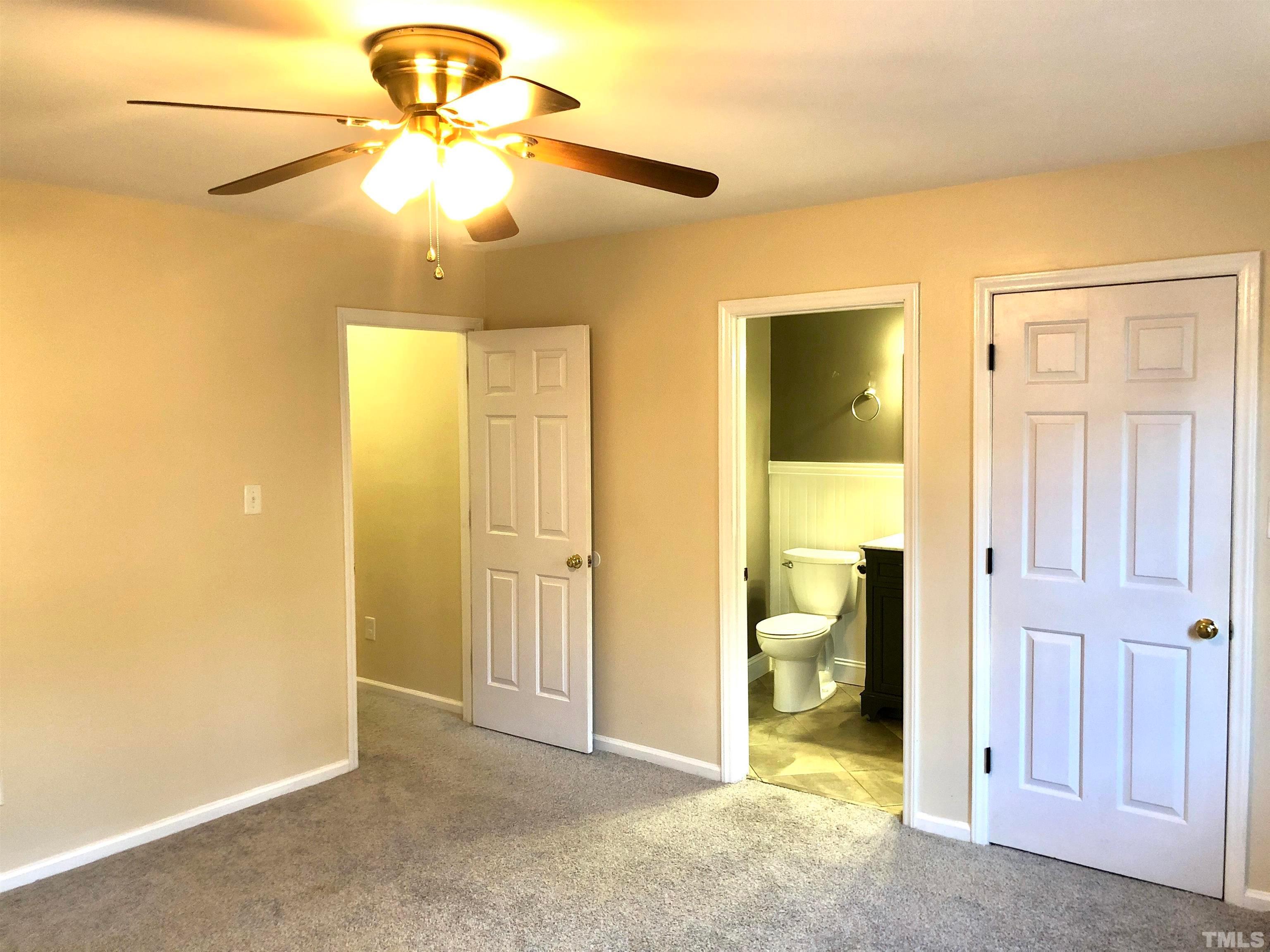 5629 Hamstead Crossing Raleigh, NC 27612 - Photo 17 of 28 a view of a room with a chandelier fan and closet