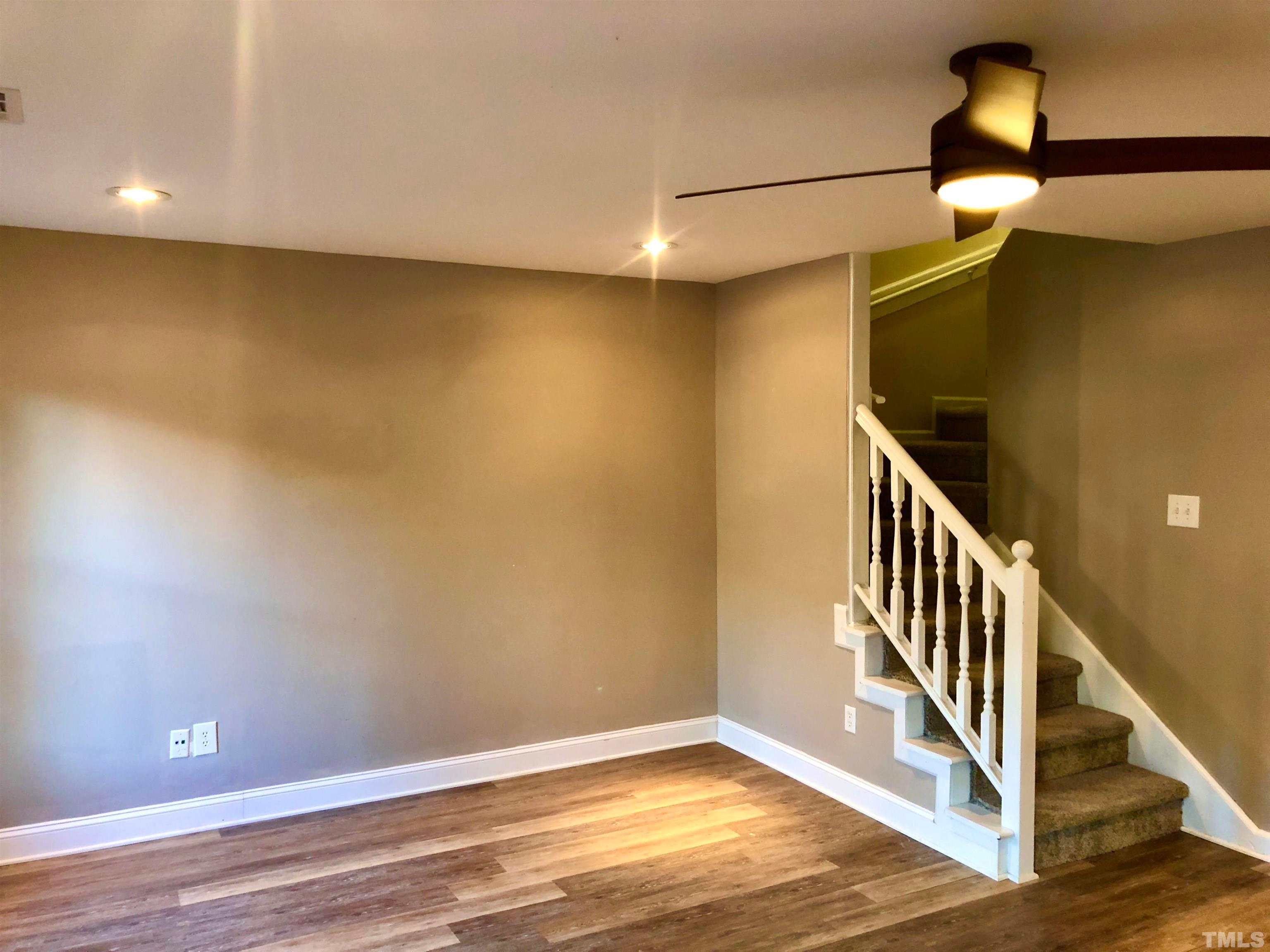 5629 Hamstead Crossing Raleigh, NC 27612 - Photo 2 of 28 a view of an empty room with wooden floor