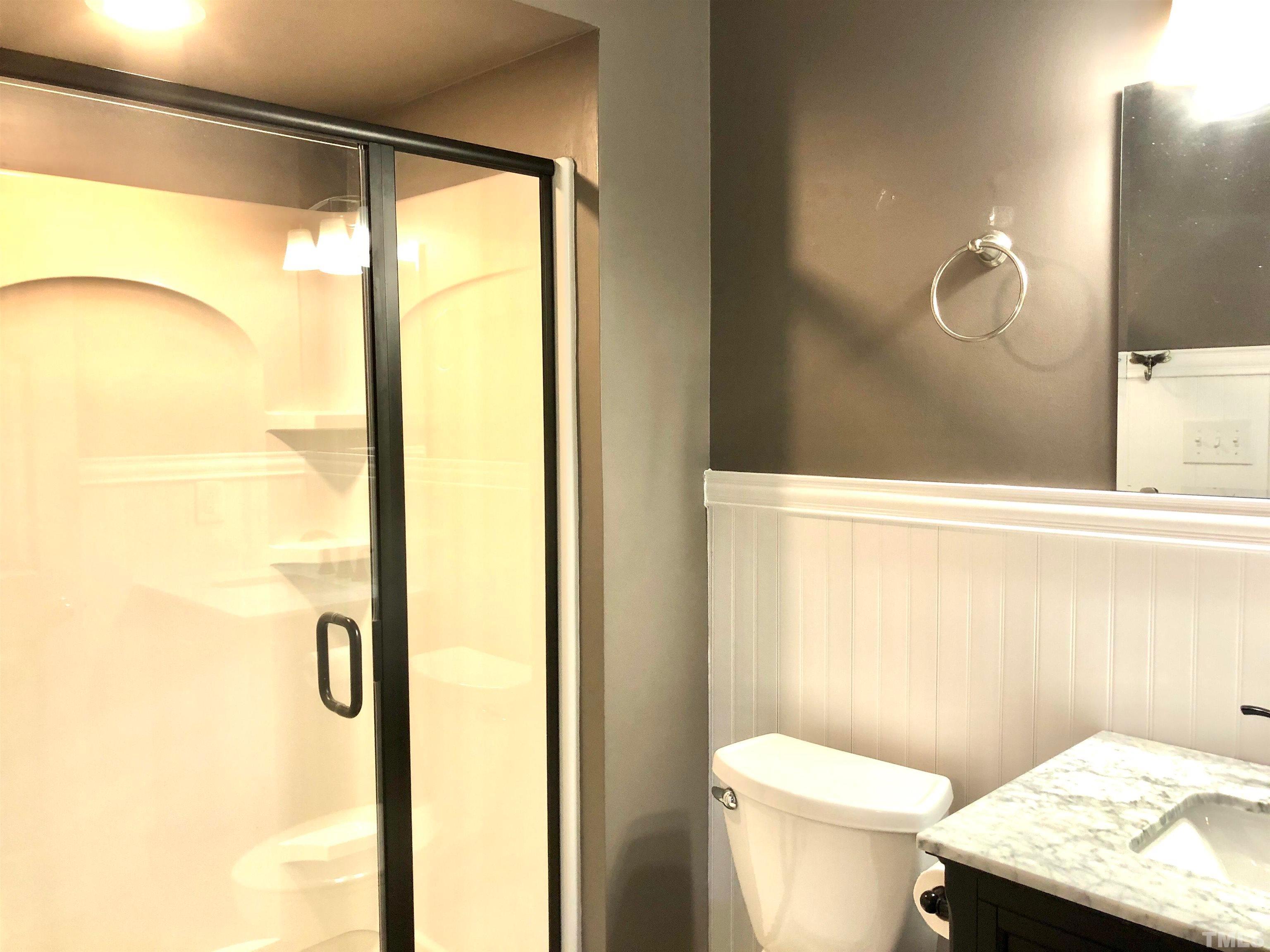 5629 Hamstead Crossing Raleigh, NC 27612 - Photo 21 of 28 a bathroom with a granite countertop sink toilet and shower