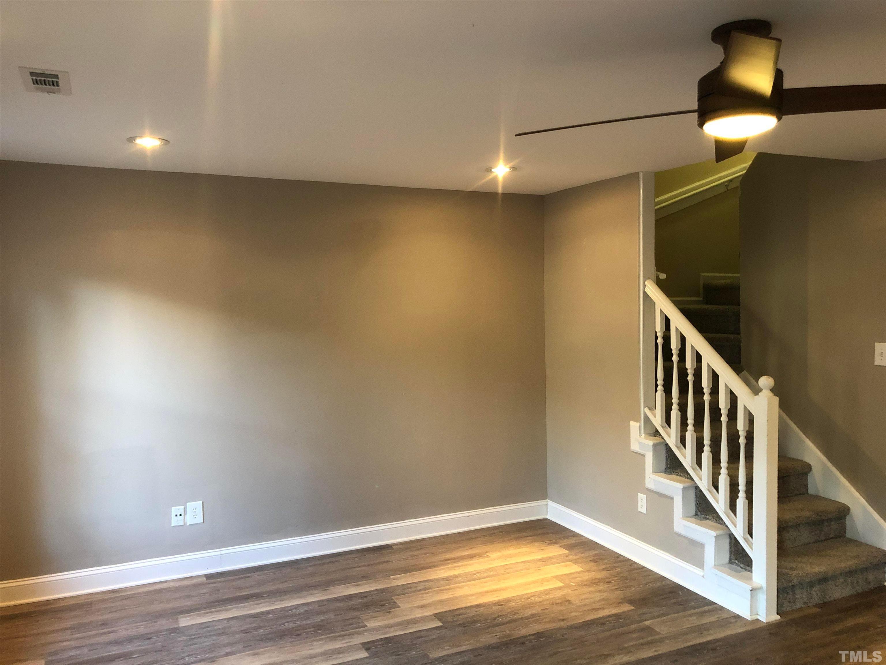 5629 Hamstead Crossing Raleigh, NC 27612 - Photo 3 of 28 a view of an empty room with wooden floor