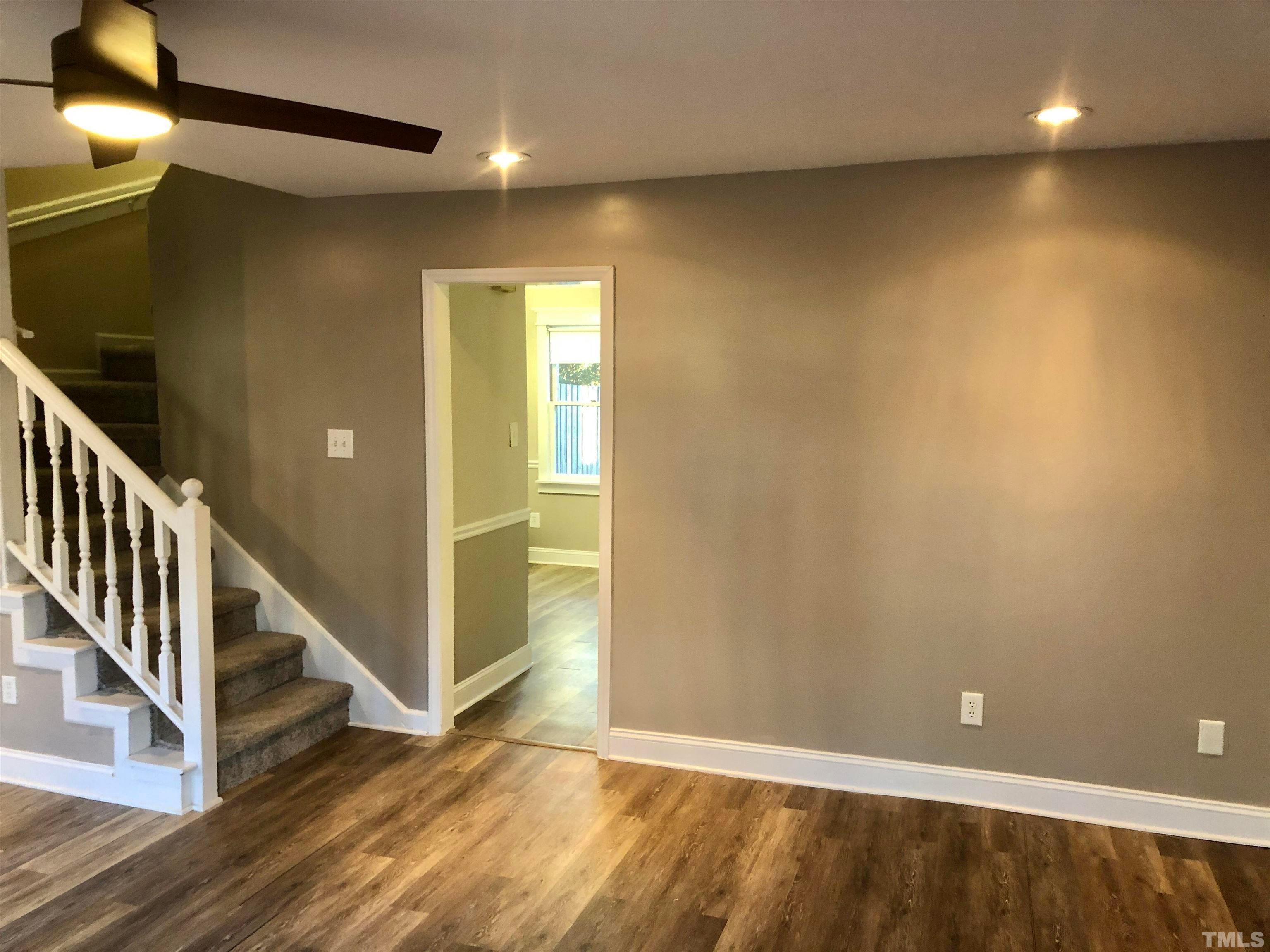 5629 Hamstead Crossing Raleigh, NC 27612 - Photo 4 of 28 wooden floor in a hall with a window