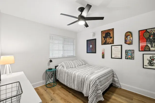 a bedroom with a bed and painting on the wall