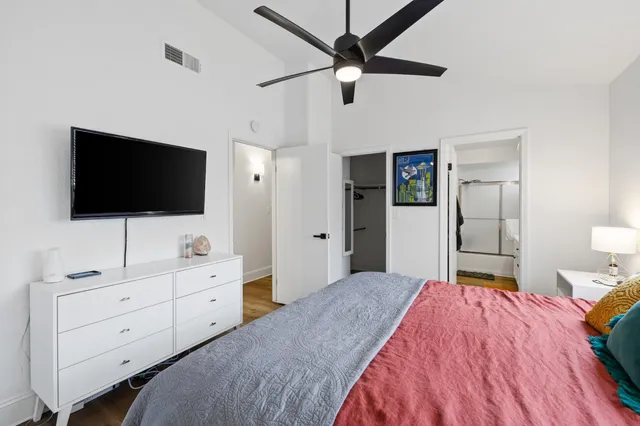 a bedroom with a bed and a flat screen tv in it