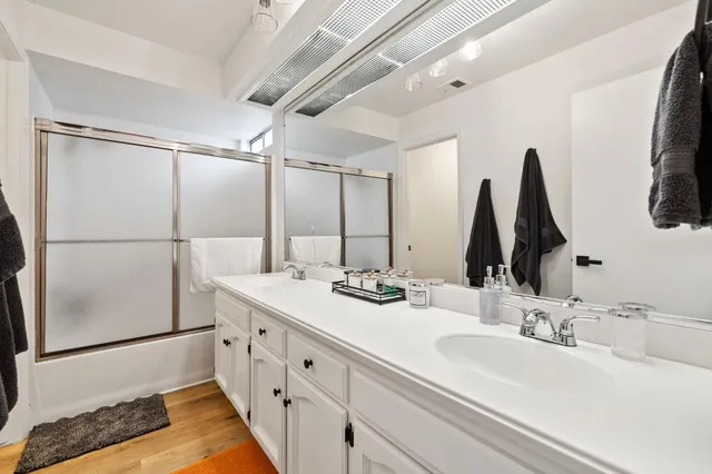 a bathroom with a double vanity sink and mirror