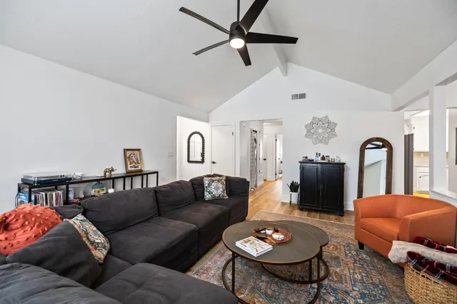 a living room with furniture a rug and a chandelier