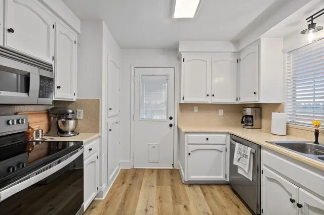 a view of a kitchen with electric appliances