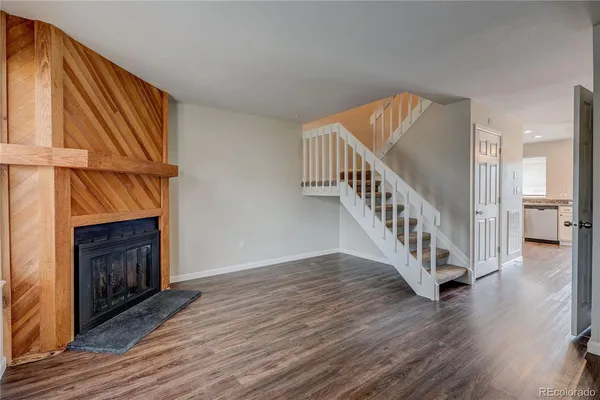 a view of an entryway with wooden floor fire place