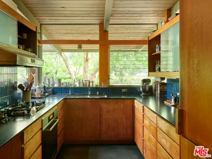 a view of a kitchen with a sink and cabinets