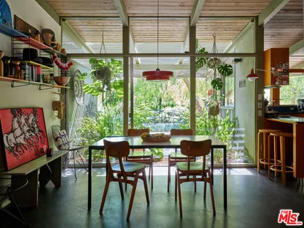 a dining room with furniture window and wooden floor