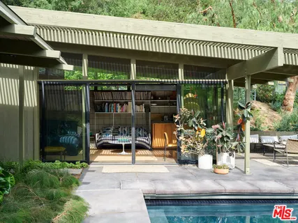 a view of a patio with table and chairs