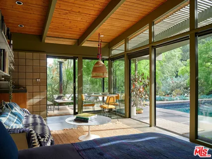 a living room with a large window and a floor