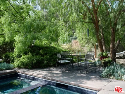 a view of backyard with seating area and green space