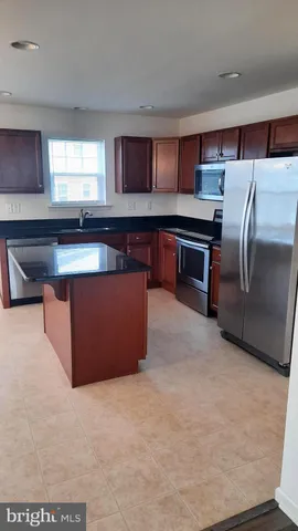 a kitchen with stainless steel appliances a refrigerator and a stove