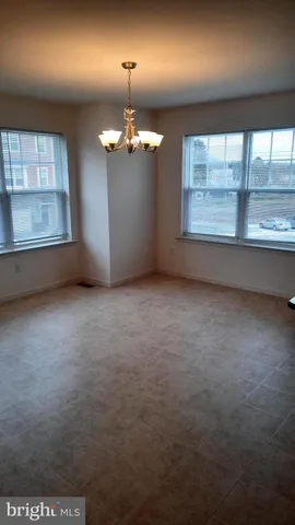 an empty room with a empty space and windows