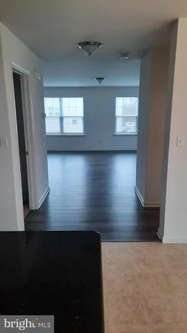 a view of wooden floor and windows in a room