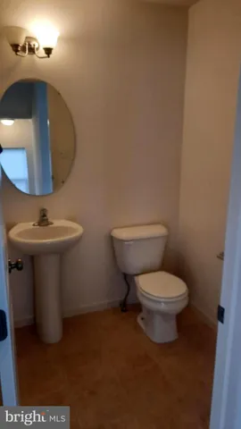 a bathroom with a toilet and a mirror