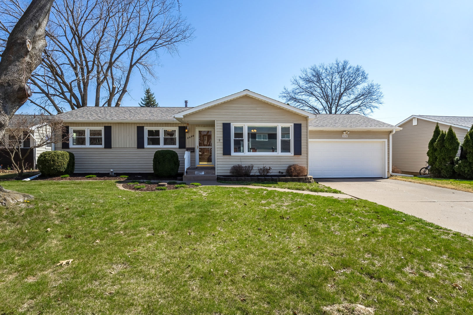 2690 9th Street East Moline, IL 61244 - Photo 1 of 19 a front view of a house with a garden