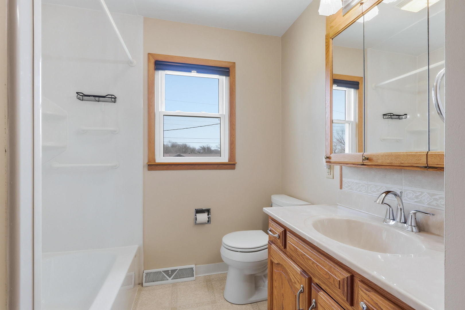 2690 9th Street East Moline, IL 61244 - Photo 11 of 19 a bathroom with a toilet sink vanity and mirror