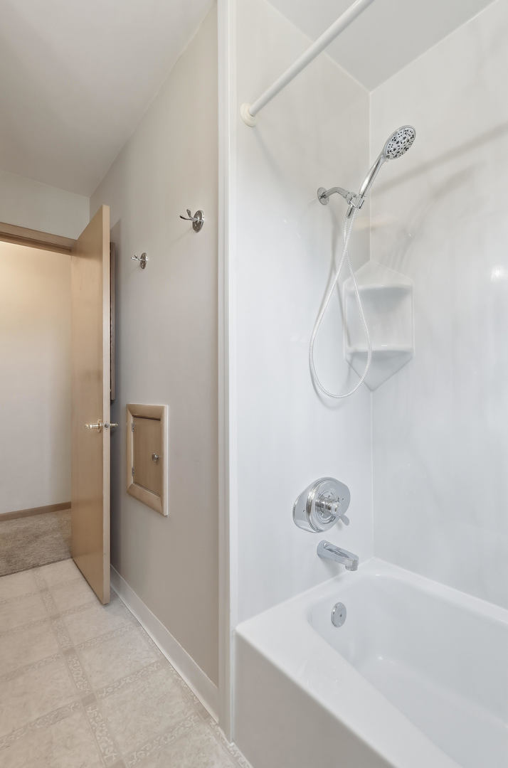 2690 9th Street East Moline, IL 61244 - Photo 12 of 19 a bathroom with a bathtub and a shower