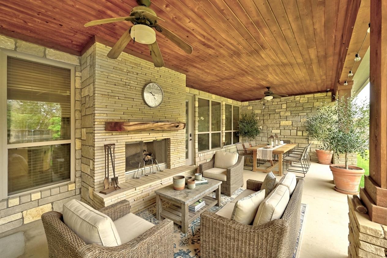 140 Winchester Road Bastrop, TX 78602 - Photo 32 of 35 View of patio / terrace with a ceiling fan, an outdoor stone fireplace, and outdoor lounge area