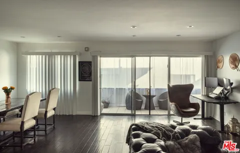 a living room with furniture and large windows