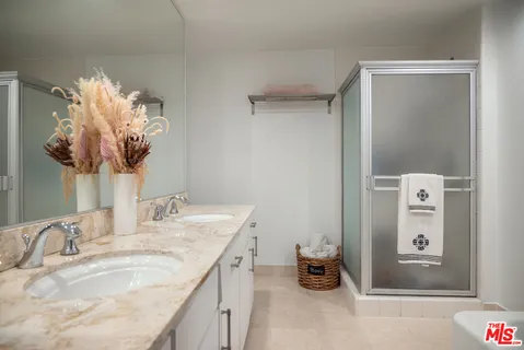 a bathroom with a sink vanity and mirror