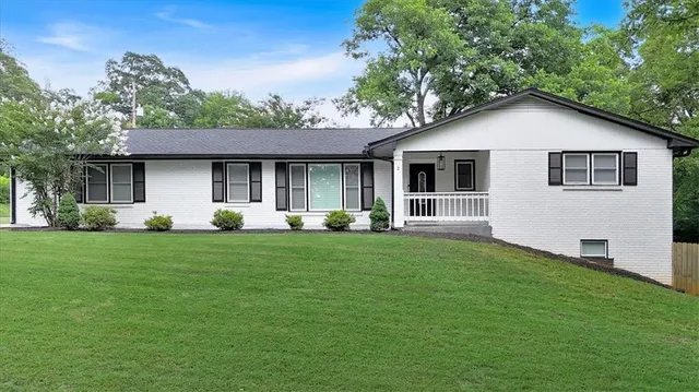 a front view of house with yard and green space