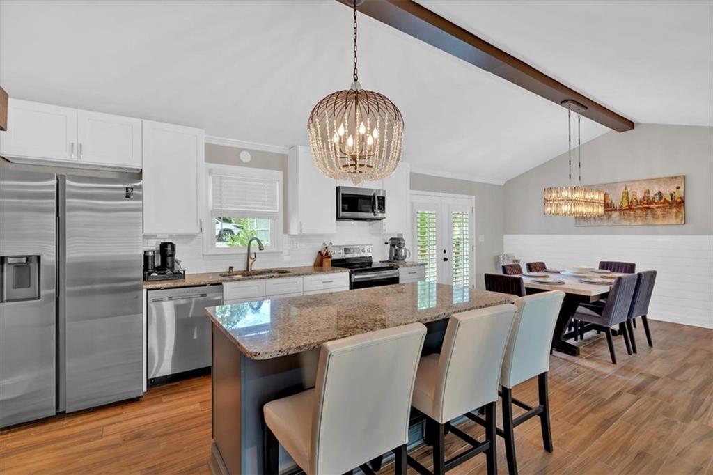 2 Milam Street Cartersville, GA 30120 - Photo 16 of 57 a kitchen with stainless steel appliances granite countertop a dining table chairs refrigerator and cabinets