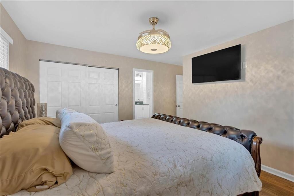 2 Milam Street Cartersville, GA 30120 - Photo 26 of 57 a bedroom with a bed and a flat tv screen on the dresser