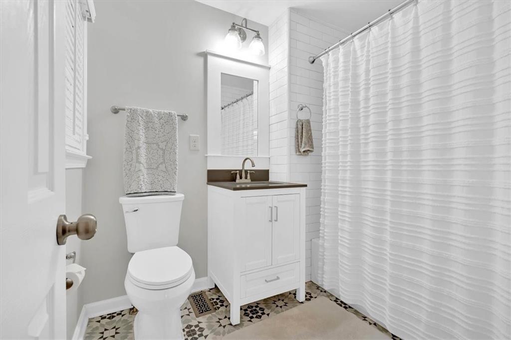2 Milam Street Cartersville, GA 30120 - Photo 27 of 57 a bathroom with a toilet and a shower curtain