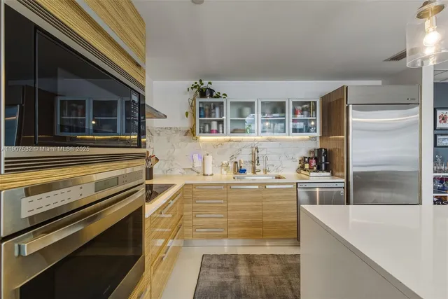 a kitchen with granite countertop stainless steel appliances and cabinets