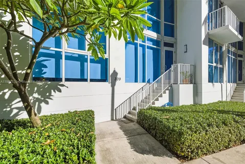 a view of a house with a small yard and plants