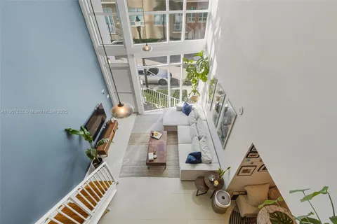 a view of living room with furniture and wooden floor