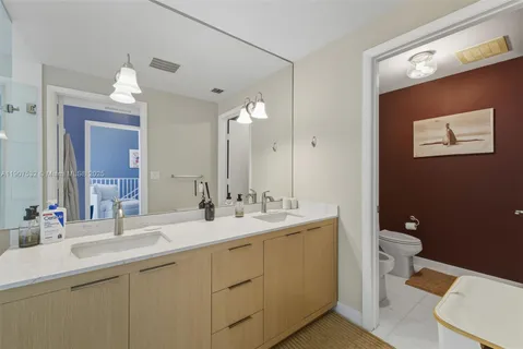 a bathroom with a toilet sink and mirror