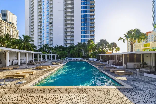 a view of a swimming pool with a lounge chairs