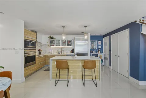 a kitchen with a table and chairs in it