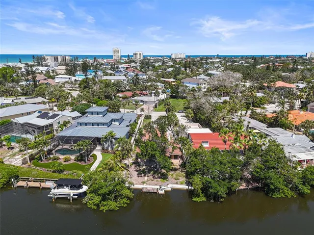 an aerial view of residential houses with outdoor space and swimming pool