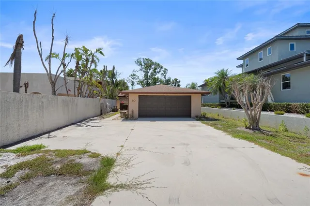 a view of a house with a yard and a garage