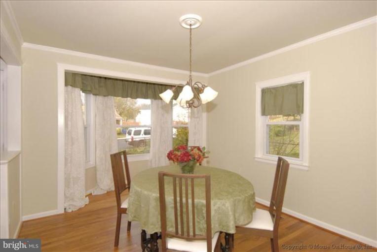 4502 Bennion Road Silver Spring, MD 20906 - Photo 3 of 7 a view of a dining room with furniture window and wooden floor