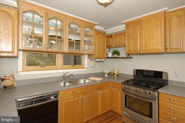 4502 Bennion Road Silver Spring, MD 20906 - Photo 4 of 7 a kitchen with stainless steel appliances granite countertop a sink stove and cabinets