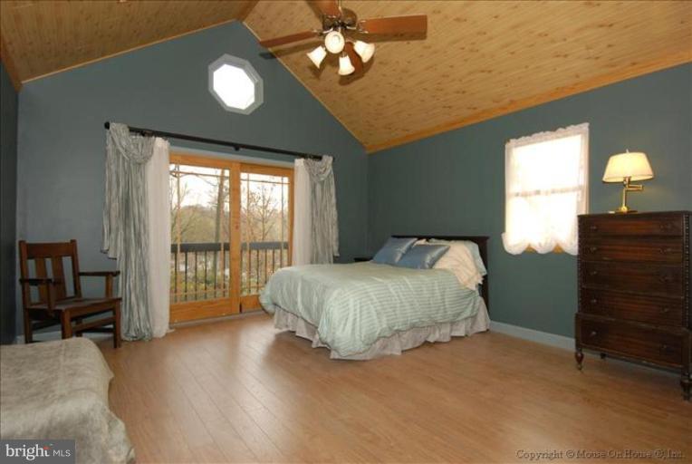 4502 Bennion Road Silver Spring, MD 20906 - Photo 6 of 7 a spacious bedroom with a bed and a dresser next to a window