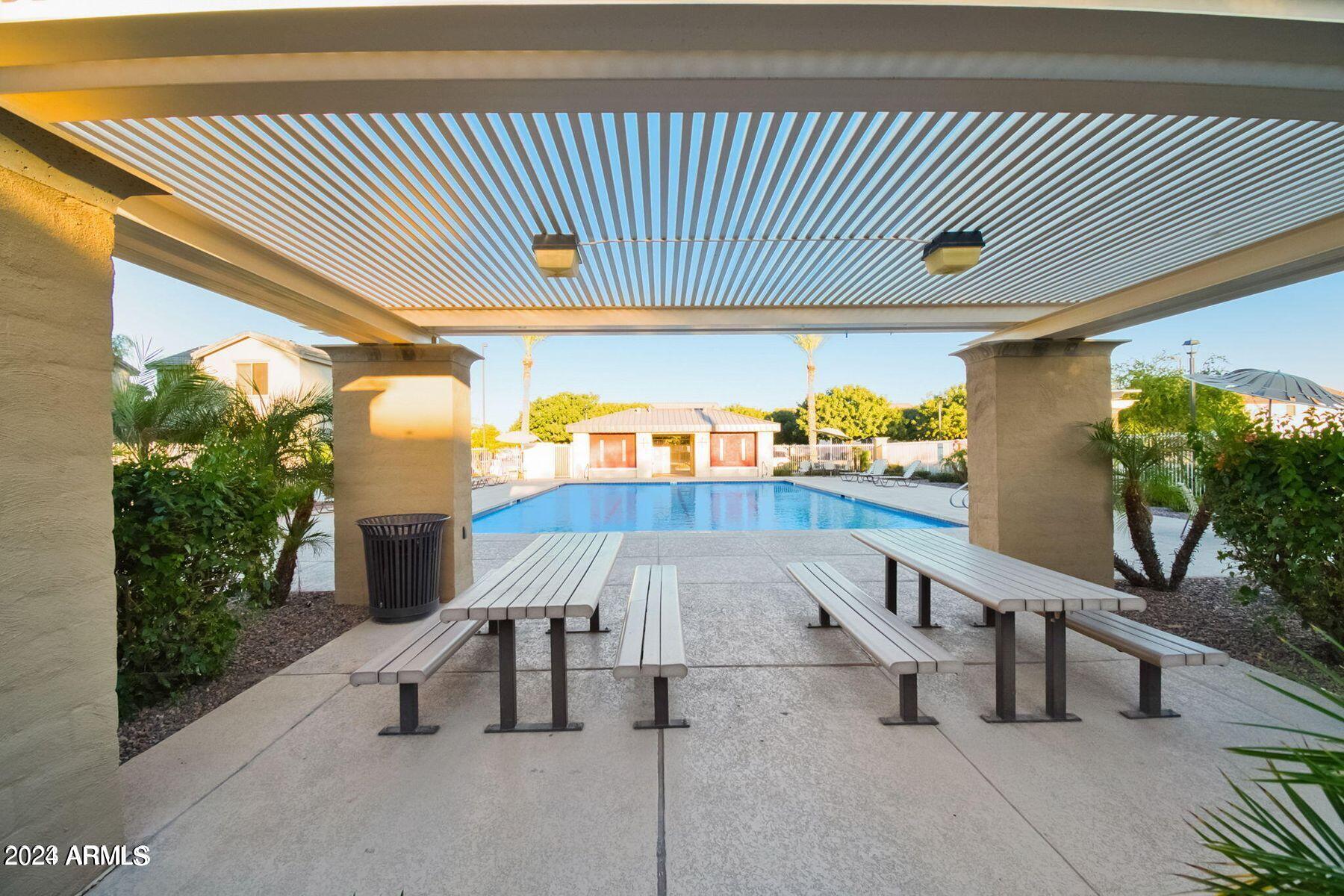1882 South Seton Avenue Gilbert, AZ 85295 - Photo 5 of 30 a view of a swimming pool with a chairs and table in a patio