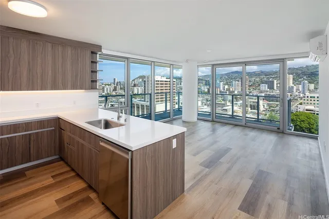 a kitchen with counter top space and wooden floor