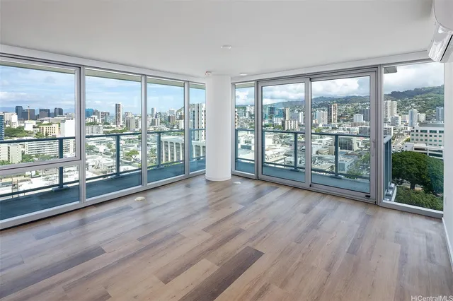 wooden floor in an empty room with a large window