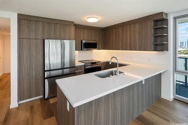 a kitchen with stainless steel appliances a refrigerator and a sink